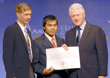 Left to right: Sasha Alyson, Khamla Panyasouk, and Bill Clinton, as the former president presented a special recognition to Big Brother Mouse at the Clinton Global Initiative meeting in Hong Kong.